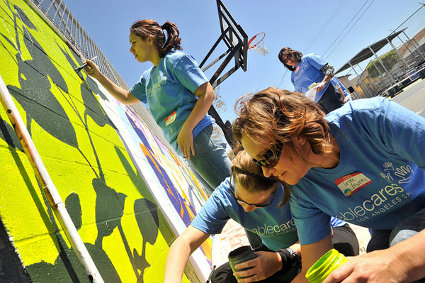 volunteers paint mural